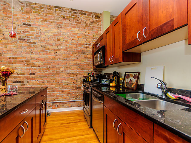 1344 West Madison Street, Unit 303 Chicago, IL 60607 - Photo 10 of 20 a kitchen with stainless steel appliances a sink stove and cabinets