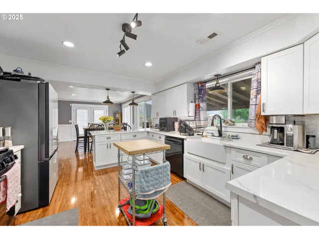 a kitchen with a sink appliances and cabinets