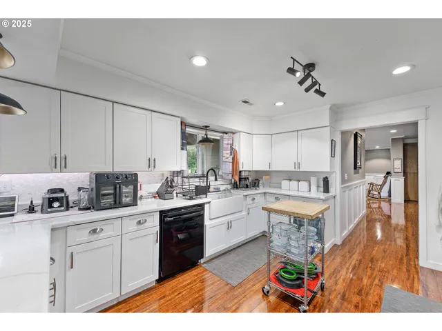 a kitchen with stainless steel appliances kitchen island granite countertop a sink and cabinets