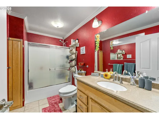 a bathroom with a sink a toilet a mirror and shower