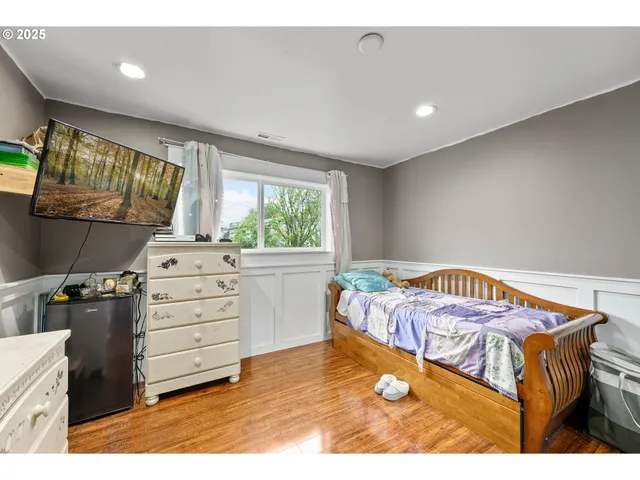 a bedroom with a bed and a table