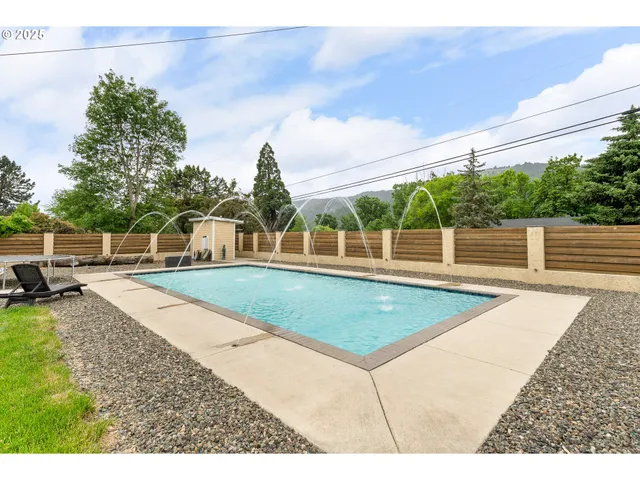 a view of a swimming pool with an outdoor seating