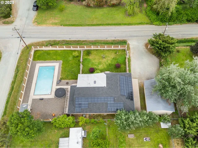 an aerial view of a house with a yard
