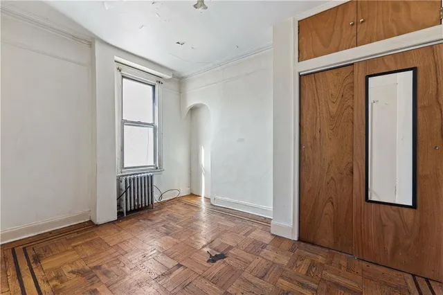 a view of a room with wooden floor and windows