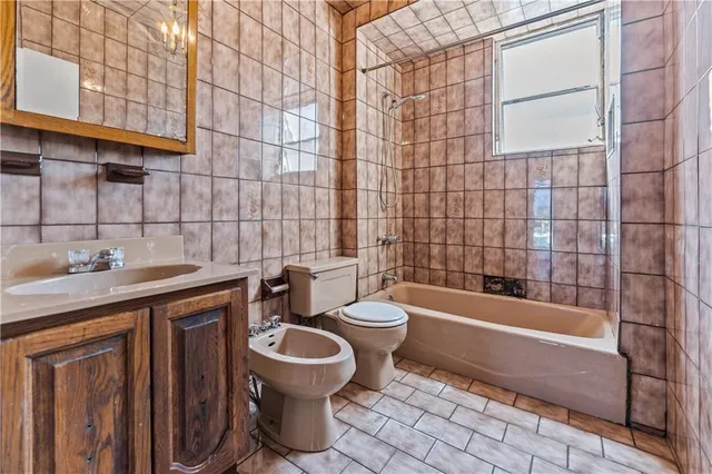 a bathroom with a sink a toilet and bathtub