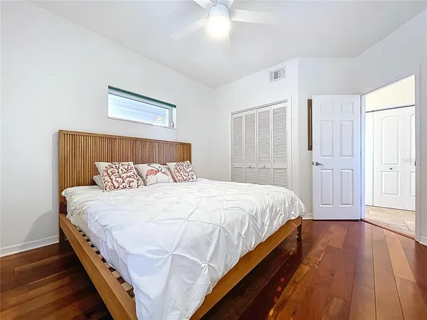 a large bed sitting in a bedroom next to a window