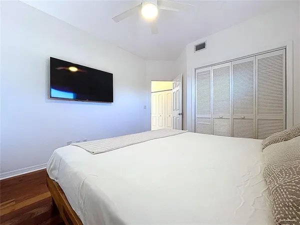 a bedroom with a bed and a flat screen tv
