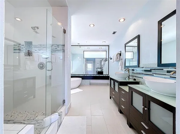 a bathroom with a granite countertop sink mirror and double