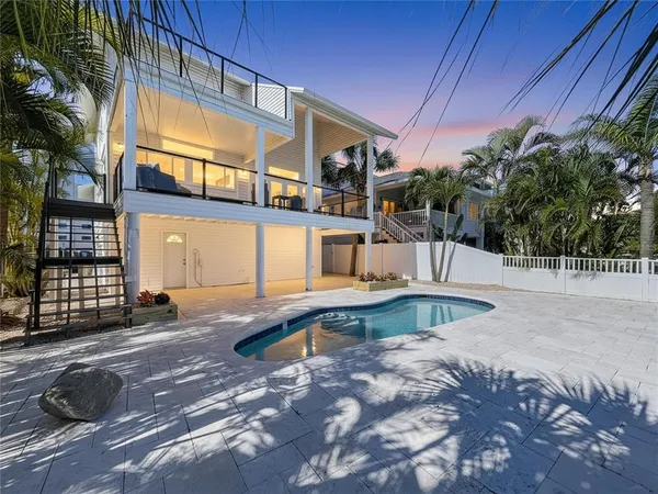 a swimming pool with outdoor seating and yard