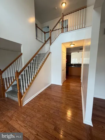 a view of entryway and hall with wooden floor
