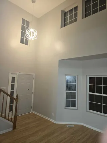 a view of livingroom with hardwood floor and front door