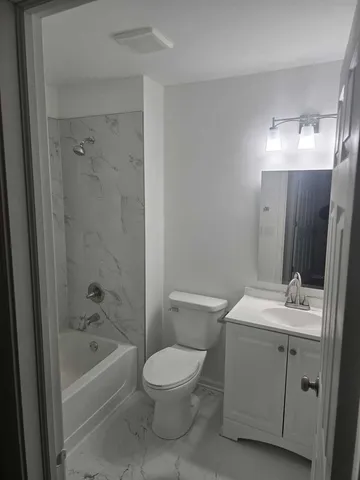 a bathroom with a sink toilet and mirror