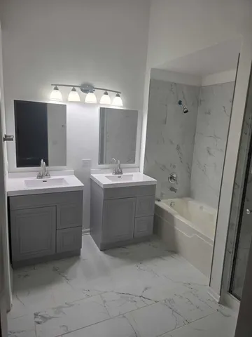 a bathroom with a bathtub and a shower