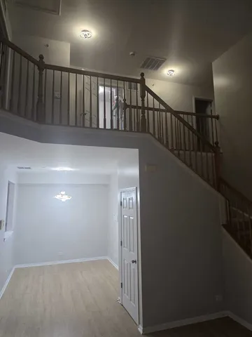 a view of staircase with railing and white walls