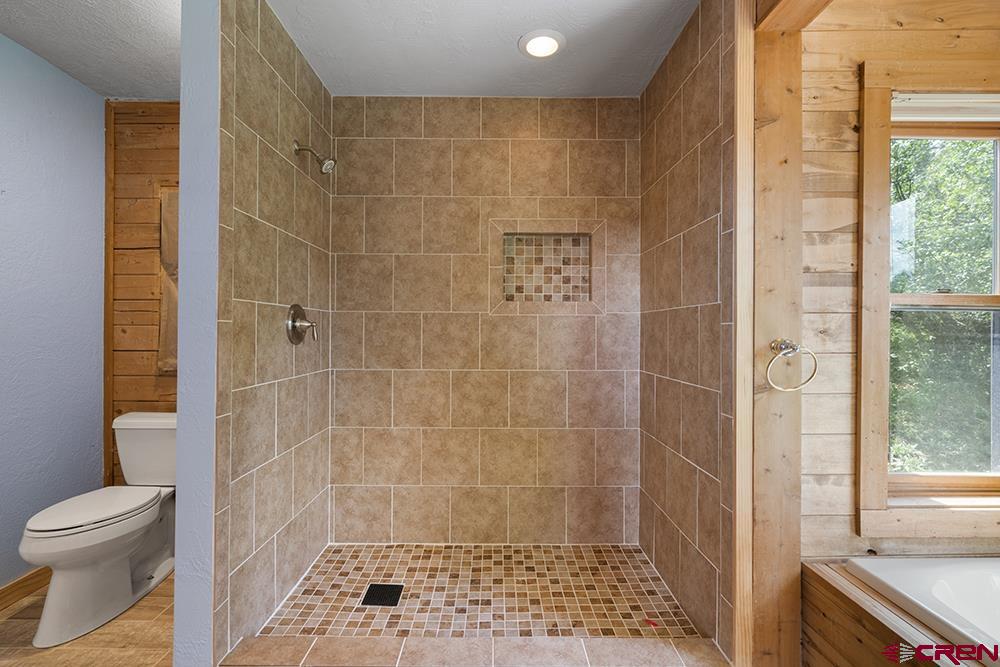 154 N Road Durango, CO 81303 - Photo 16 of 35 a bathroom with a shower and a toilet