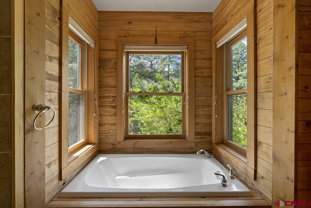 154 N Road Durango, CO 81303 - Photo 17 of 35 a bathroom with a tub and a window