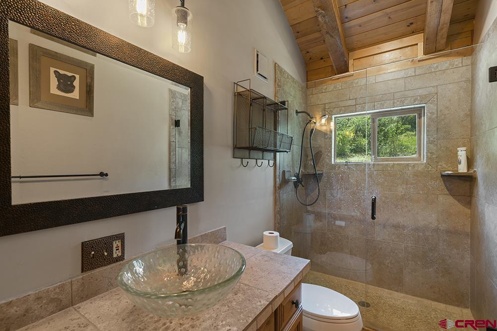 154 N Road Durango, CO 81303 - Photo 19 of 35 a bathroom with a sink a toilet and shower