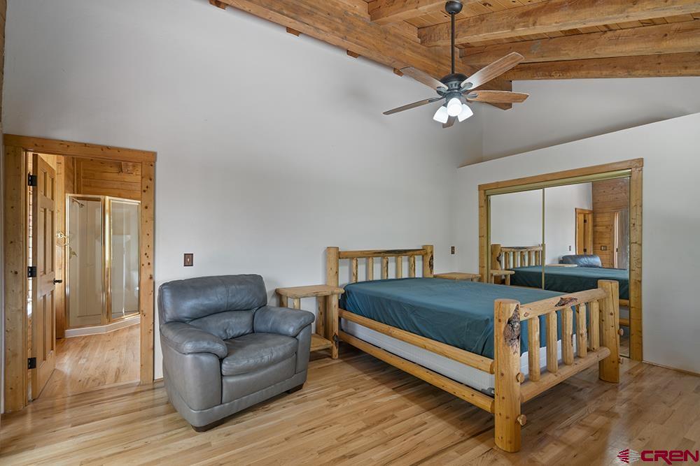 154 N Road Durango, CO 81303 - Photo 21 of 35 a bedroom with a bed and a chandelier