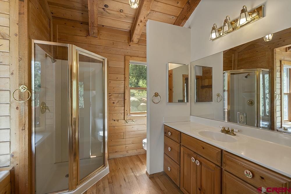 154 N Road Durango, CO 81303 - Photo 22 of 35 a spacious bathroom with a shower sink and mirror