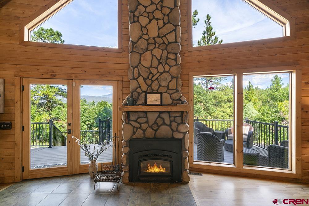 154 N Road Durango, CO 81303 - Photo 5 of 35 a living room with a fireplace and a floor to ceiling window