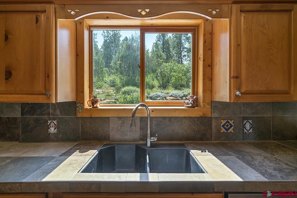 154 N Road Durango, CO 81303 - Photo 9 of 35 a kitchen with a sink and large window