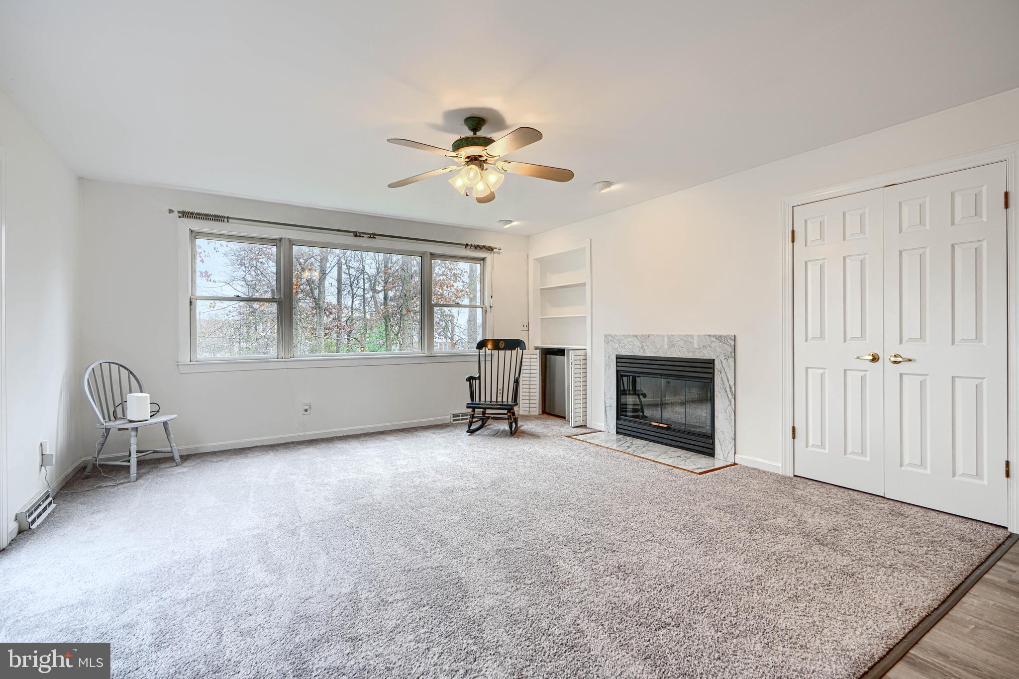 2508 Perring Woods Road Baltimore, MD 21234 - Photo 18 of 42 wooden floor fireplace and windows in an empty room
