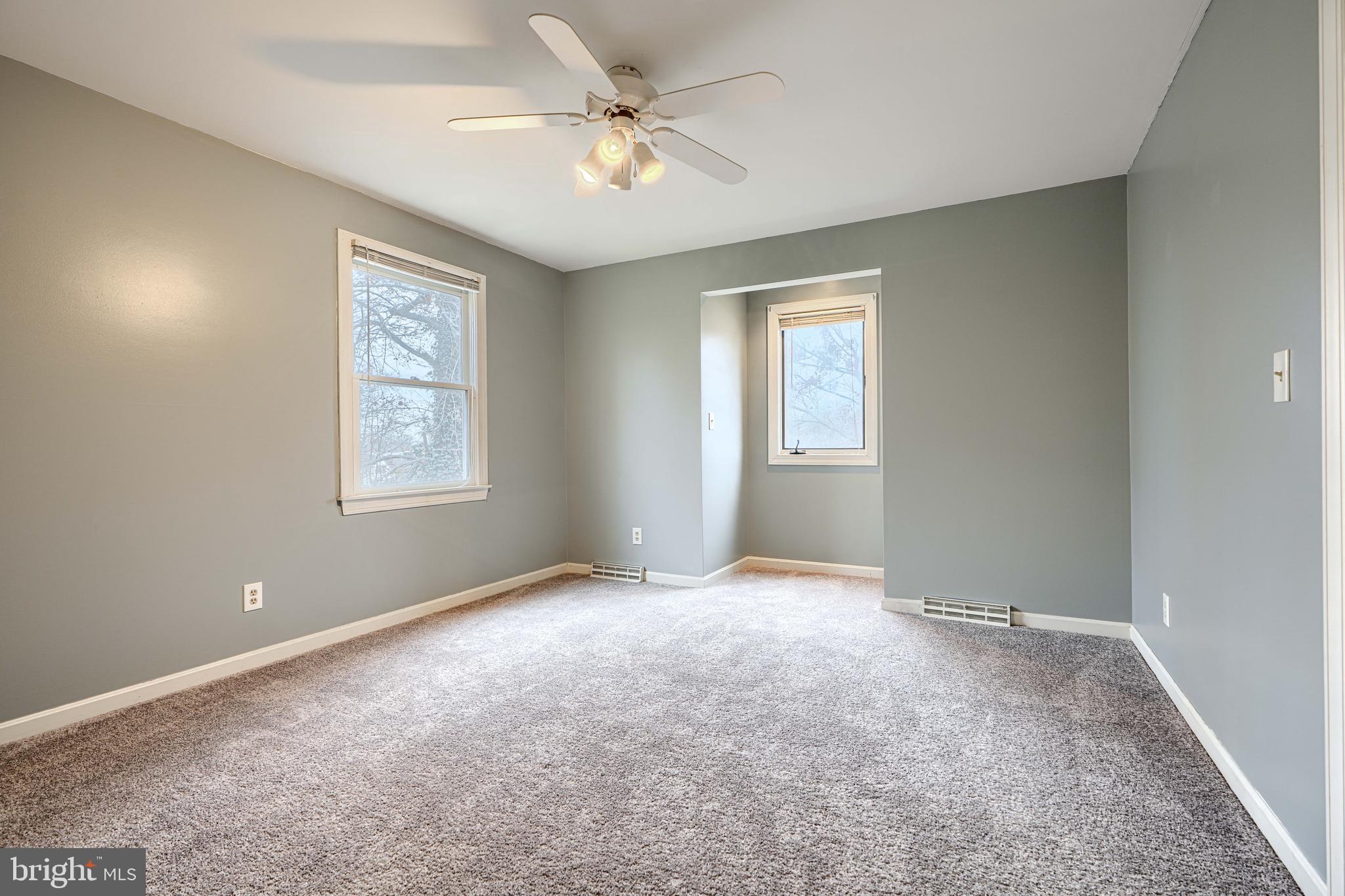 2508 Perring Woods Road Baltimore, MD 21234 - Photo 22 of 42 an empty room with windows and fan