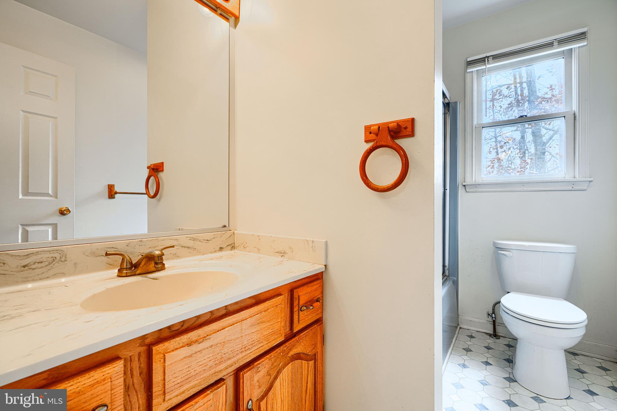 2508 Perring Woods Road Baltimore, MD 21234 - Photo 28 of 42 a bathroom with a sink toilet and a mirror