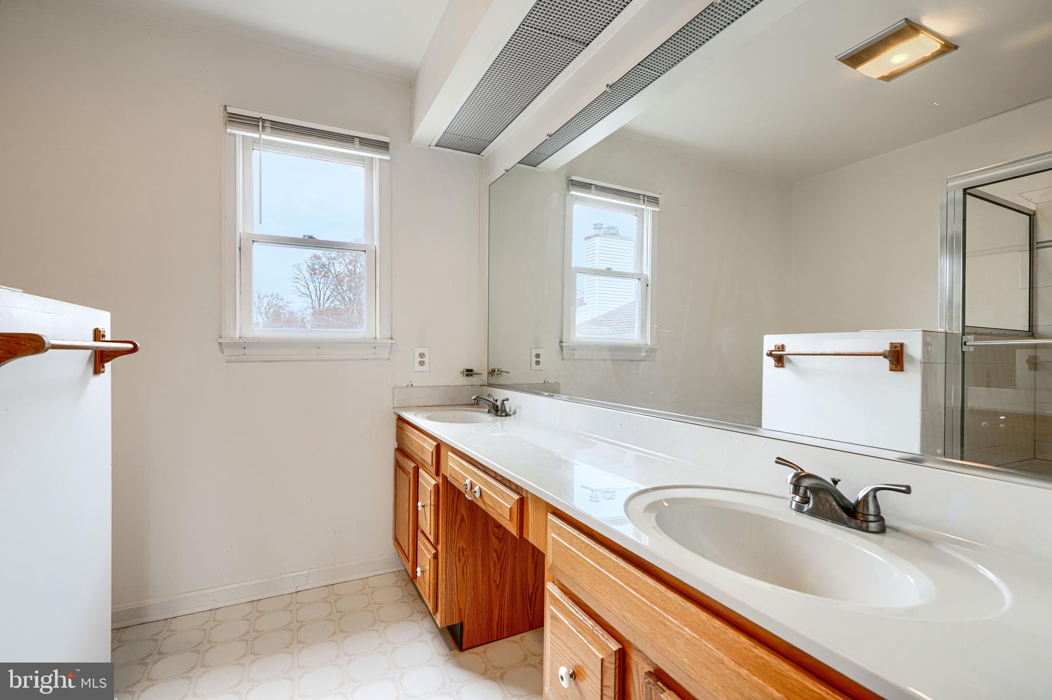 2508 Perring Woods Road Baltimore, MD 21234 - Photo 35 of 42 a bathroom with a granite countertop sink and a mirror