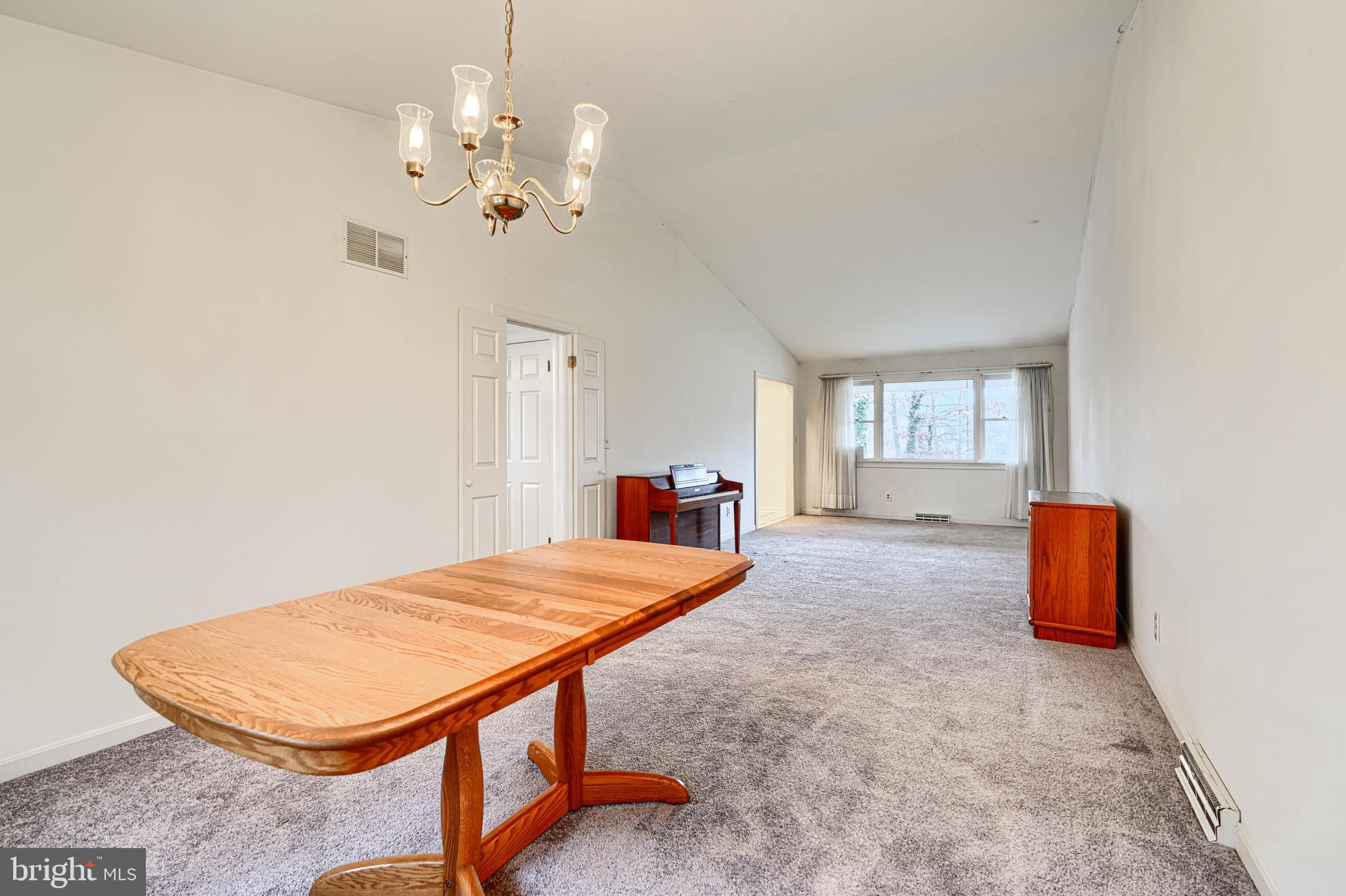 2508 Perring Woods Road Baltimore, MD 21234 - Photo 10 of 42 a bed room with a bed and a chandelier