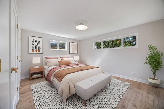 a bedroom with a bed and a potted plant