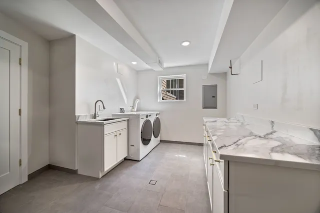 a utility room with cabinets washer and dryer