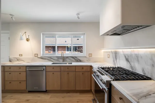 a kitchen with a sink stove and cabinets