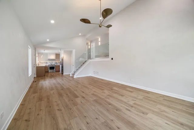 a view of a kitchen with a sink and a refrigerator