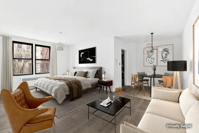 a spacious bedroom with a bed a couch and a flat screen tv