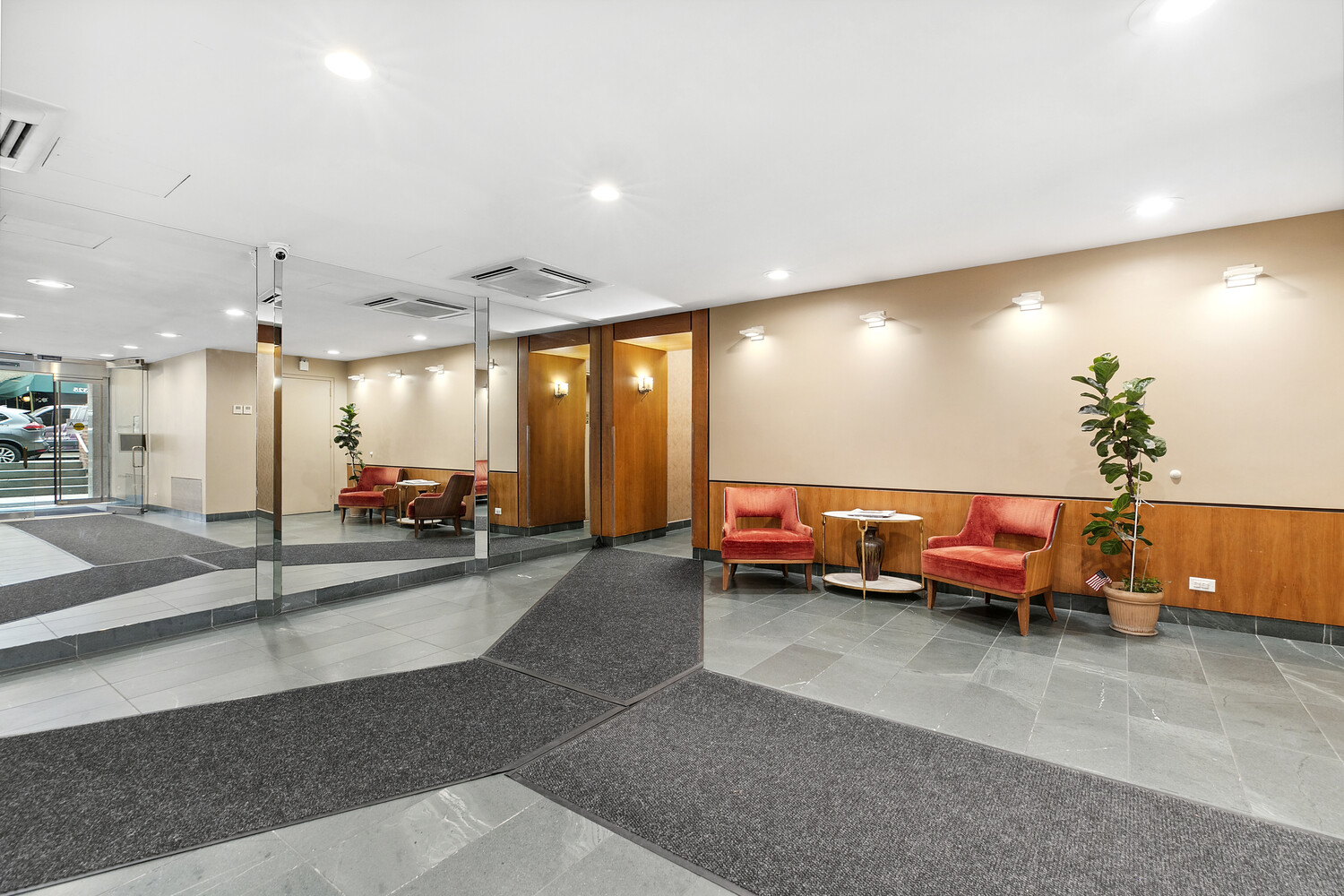 330 East 80th Street, Unit 3K Manhattan, NY 10075 - Photo 5 of 8 a lobby with a table and chairs