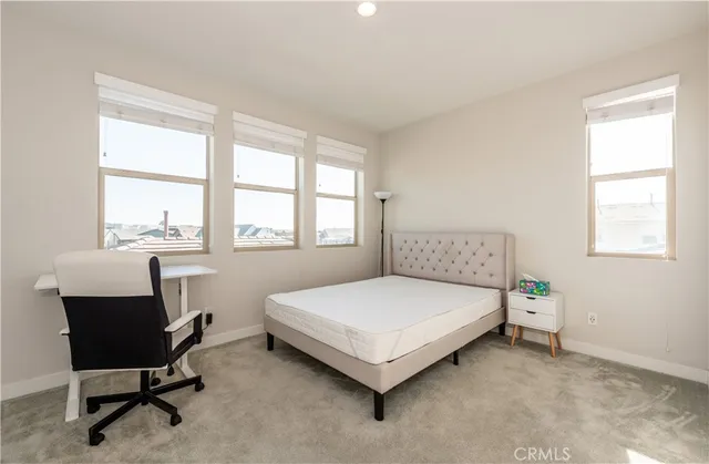 a bedroom with a bed chair and a window