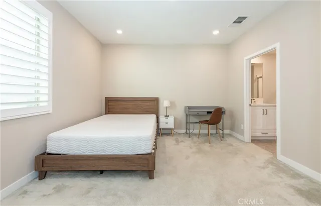 a bedroom with a bed and a chair