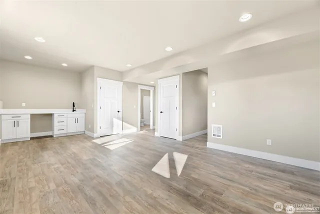 an empty room with wooden floor