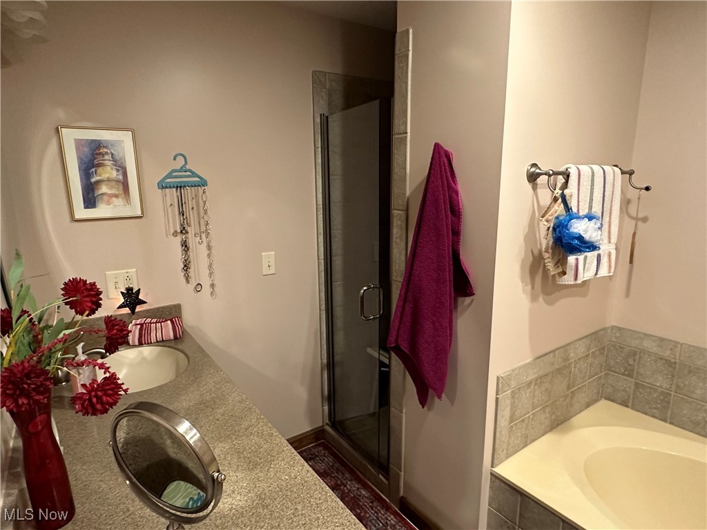 354 Big Bass Road Willard, OH 44890 - Photo 22 of 29 Bathroom featuring independent shower and bath and double sink