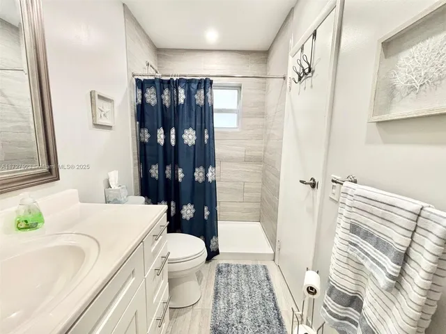 a bathroom with a sink toilet and shower
