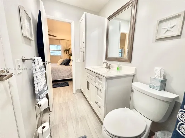 a bathroom with a double vanity sink toilet and mirror