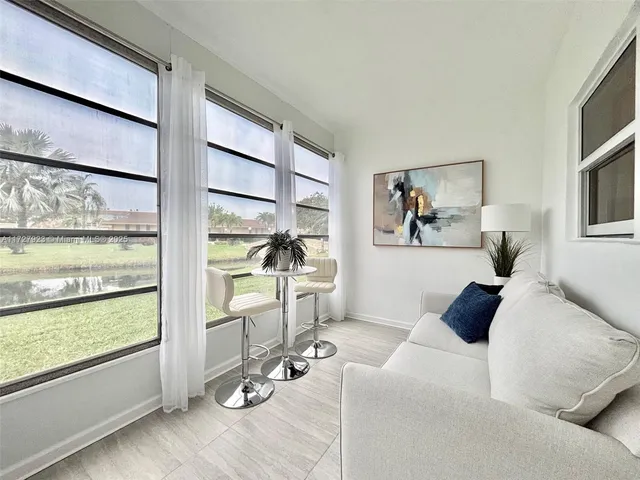 a living room with furniture and a painting on the wall