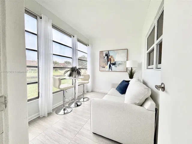 a dining room with furniture and window