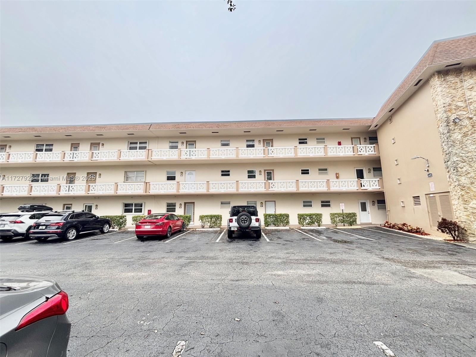 3405 Northwest 48th Avenue, Unit 407 Lauderdale Lakes, FL 33319 - Photo 43 of 44 a car parked in the parking lot