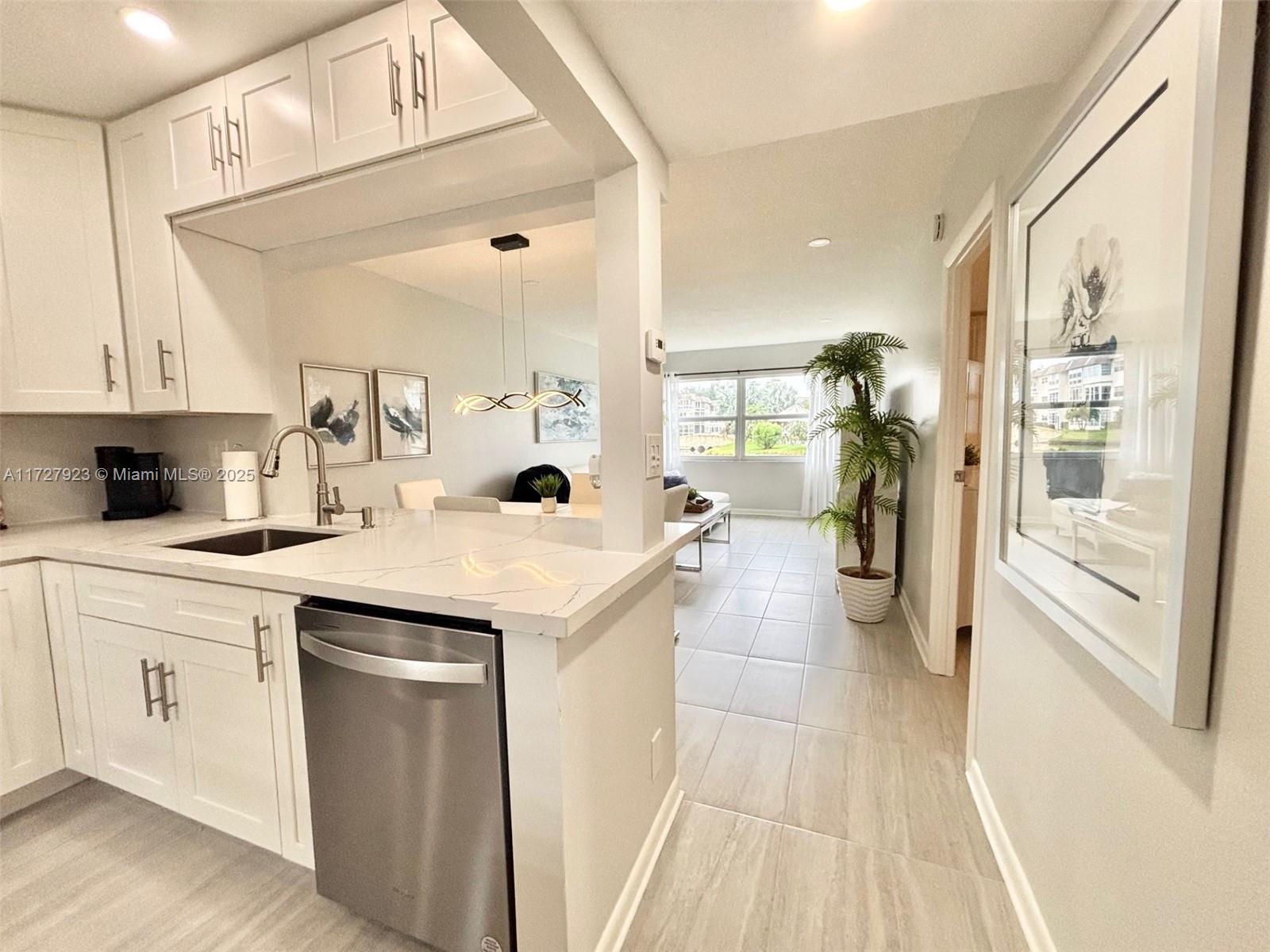 3405 Northwest 48th Avenue, Unit 407 Lauderdale Lakes, FL 33319 - Photo 10 of 44 a kitchen with a sink and cabinets