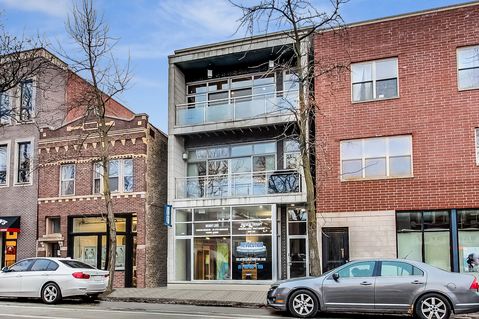 2121 West Roscoe Street, Unit 2 Chicago, IL 60618 - Photo 1 of 24 a view of a car parked in front of a building
