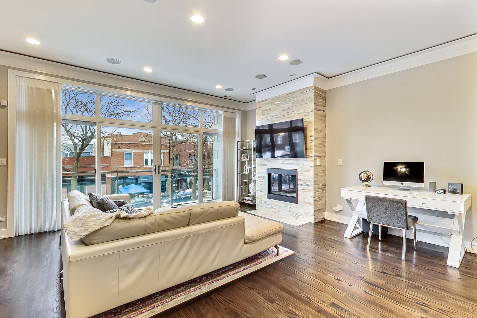 2121 West Roscoe Street, Unit 2 Chicago, IL 60618 - Photo 2 of 24 a living room with furniture and a flat screen tv