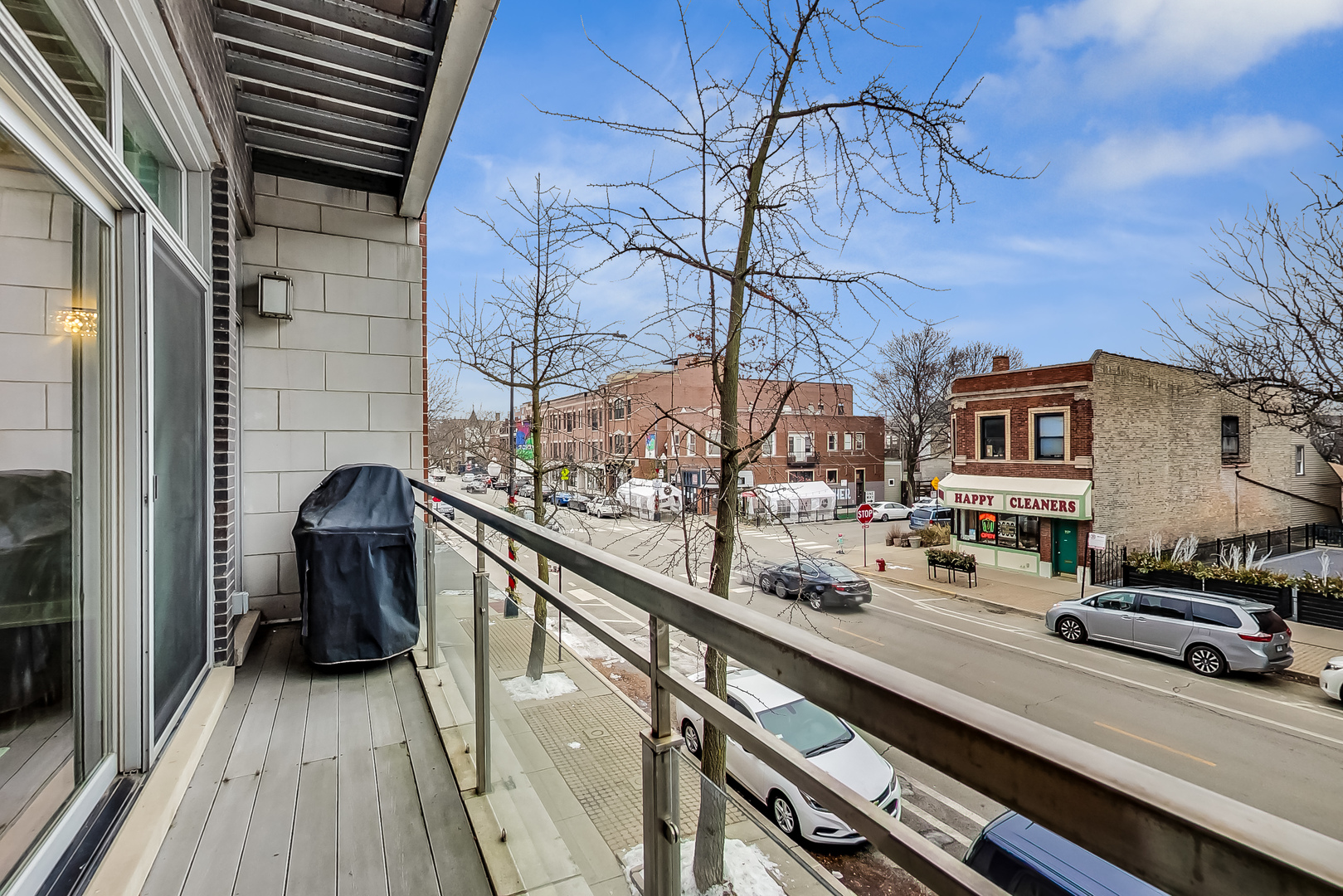 2121 West Roscoe Street, Unit 2 Chicago, IL 60618 - Photo 13 of 24 a view of a balcony with chairs and wooden fence