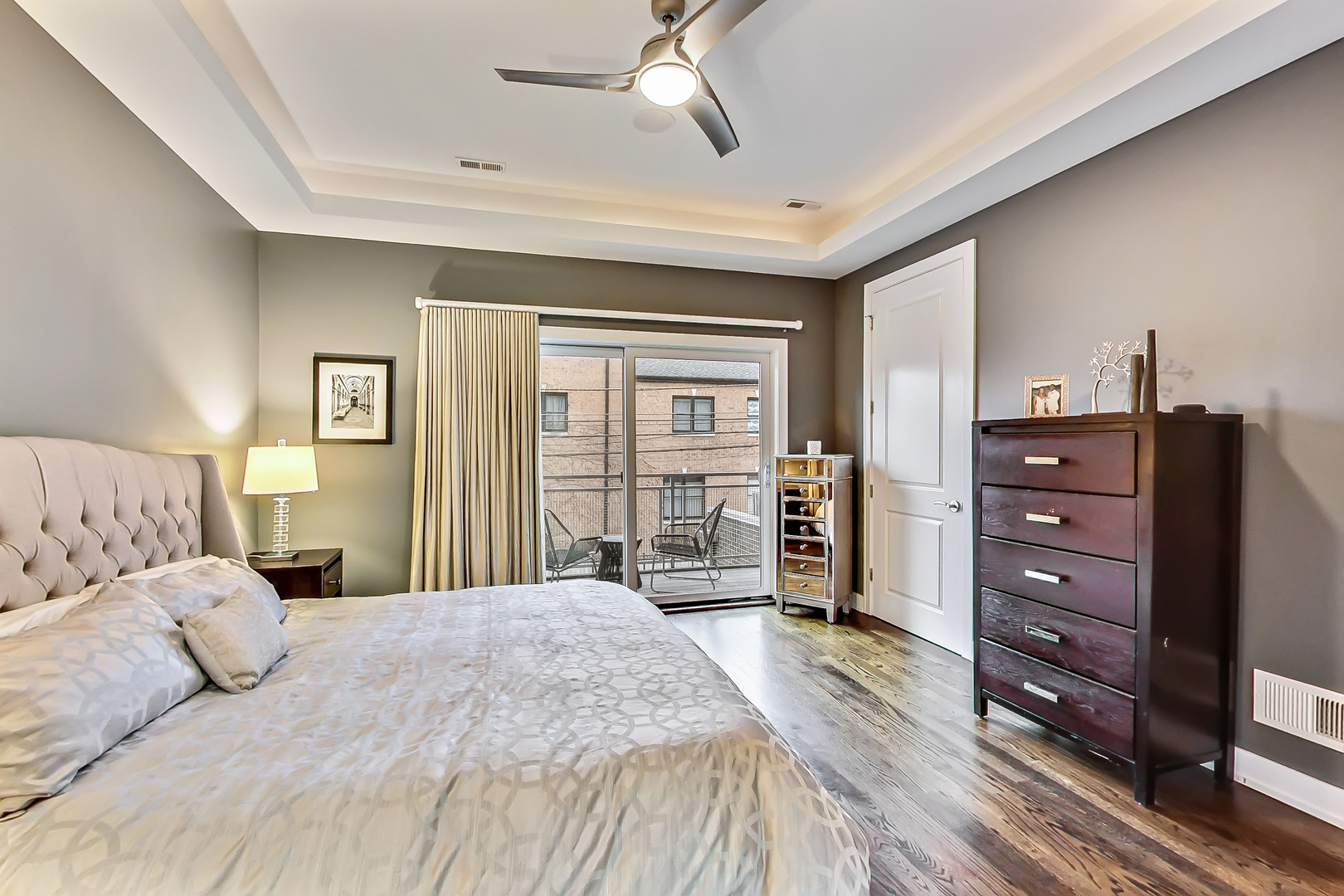 2121 West Roscoe Street, Unit 2 Chicago, IL 60618 - Photo 15 of 24 a bedroom with a large bed and a dresser